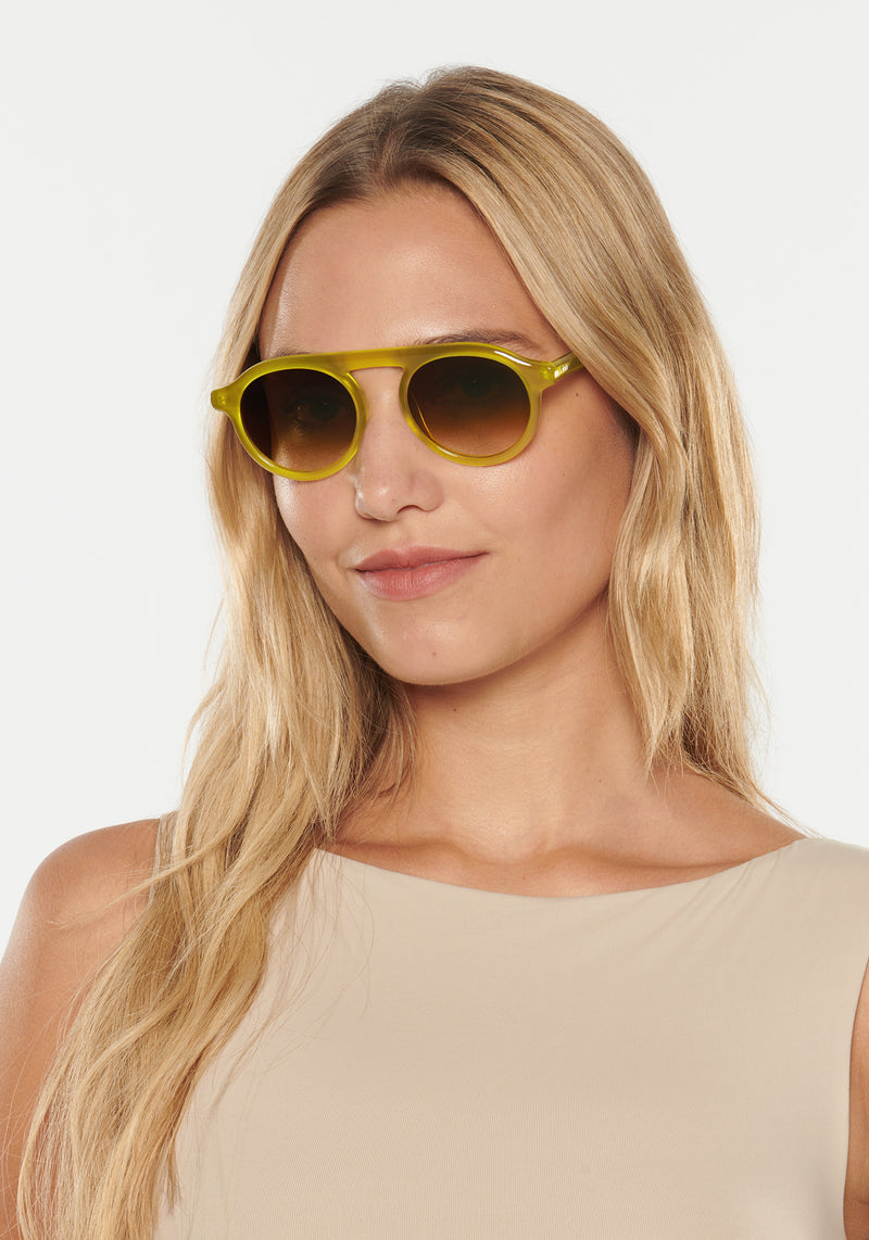 KREWE SUNGLASSES - CAMERON | Chartreuse handcrafted, luxury yellow acetate round frames womens model | Model: Erica