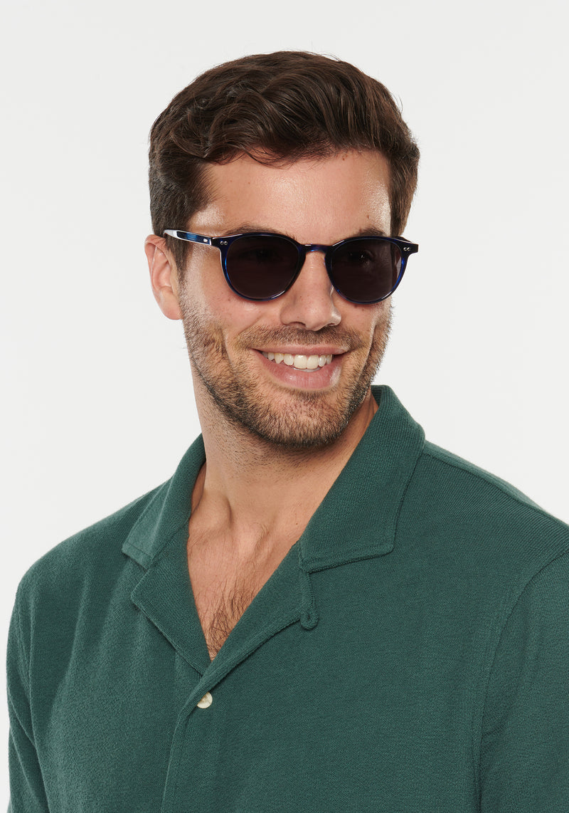 LANDRY | Indigo Tort Handcrafted, luxury dark blue indigo acetate round KREWE sunglasses mens model | Model: Douglas