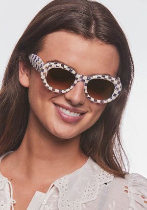 MARGARET | Gingham over Crystal Handcrafted, luxury blue and white checkered gingham acetate medium sized oval bubble frame KREWE sunglasses womens model | Model: Bentley