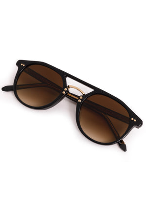 MARKLE | Black + Black Tea 18K Handcrafted, luxury black acetate medium round KREWE sunglasses with gold stainless steel metal hardware