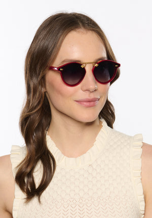 STL NYLON | Cherry 18K Handcrafted, luxury red cherry acetate round KREWE sunglasses with flat edge to edge nylon lens and 18k gold metal bridge womens model | Model: Vanessa